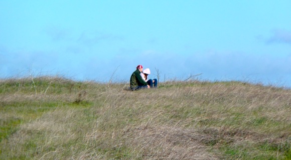 Couple atop hill near Big Dish
